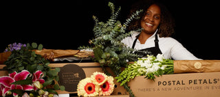 Black entrepreneur displaying flower design boxes.